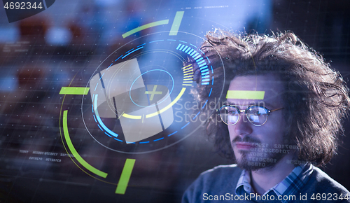 Image of man working on computer in dark office