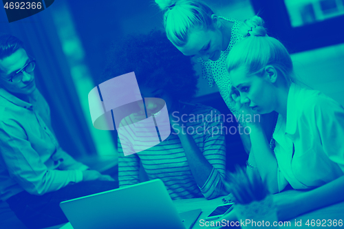 Image of Multiethnic startup business team in night office