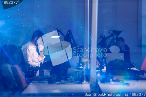 Image of businessman working using a laptop in startup office