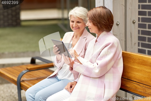 Image of senior women with tablet computer in city