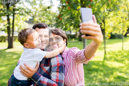 Image of happy family taking selfie at summer park