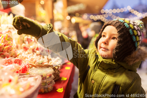 Image of little boy at christmas market candy shop