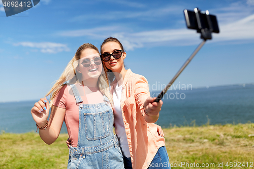 Image of teenage girls or friends taking selfie in summer