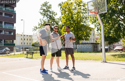 Image of men with smartphone at basketball playground