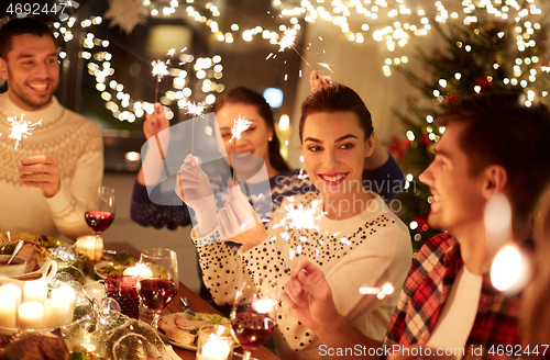 Image of happy friends celebrating christmas at home feast