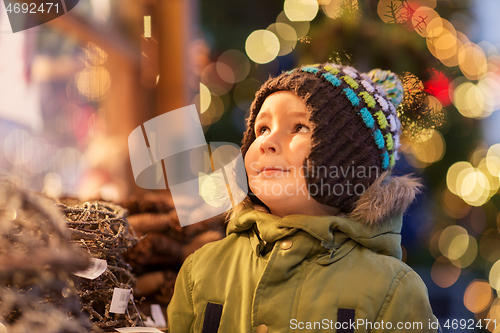 Image of happy little boy at christmas market in winter