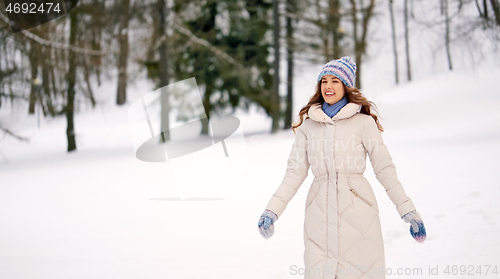 Image of happy smiling woman outdoors in winter forest