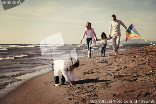 Image of happy family enjoying vecation during autumn day