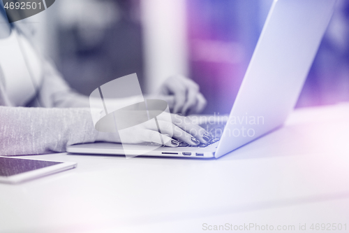 Image of businesswoman using a laptop in startup office