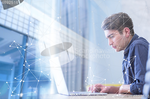 Image of businessman working using a laptop in startup office