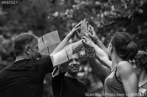 Image of runners giving high five to each other