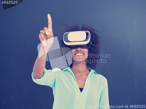 Image of black girl using VR headset isolated on gray background