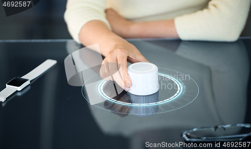 Image of woman with control knob on interactive panel