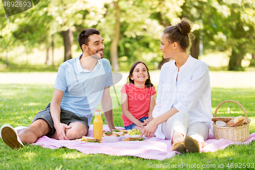 Image of happy family having picnic at summer park