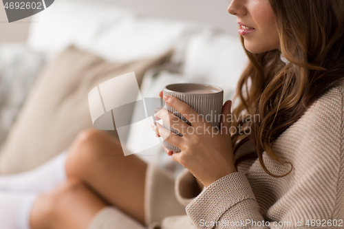 Image of close up of happy woman with cup of coffee at home