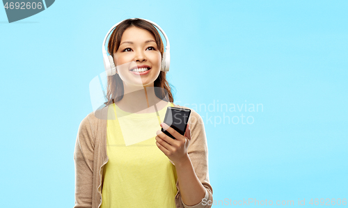 Image of asian woman in headphones listening to music