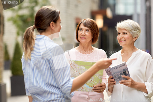 Image of passerby showing direction to senior women in city