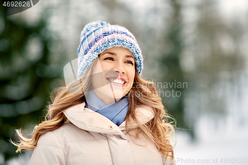 Image of portrait of happy smiling woman outdoors in winter