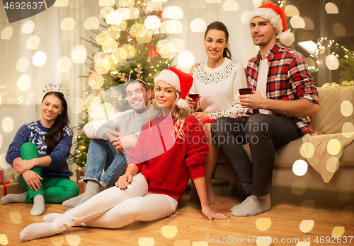 Image of friends celebrating christmas and drinking wine