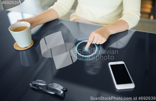 Image of woman with coffee using interactive panel