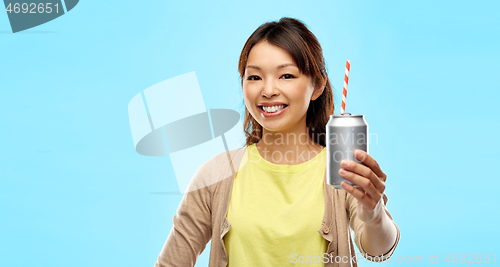 Image of happy asian woman holding can drink with straw
