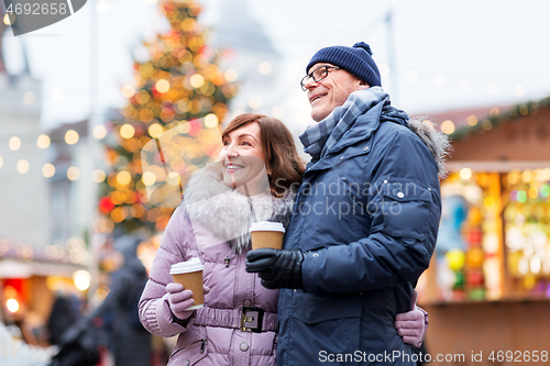 Image of senior couple with coffee at christmas market