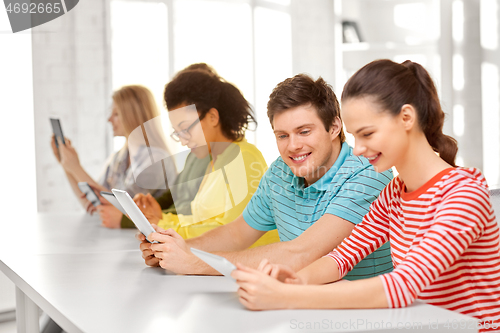 Image of high school students with tablet computers