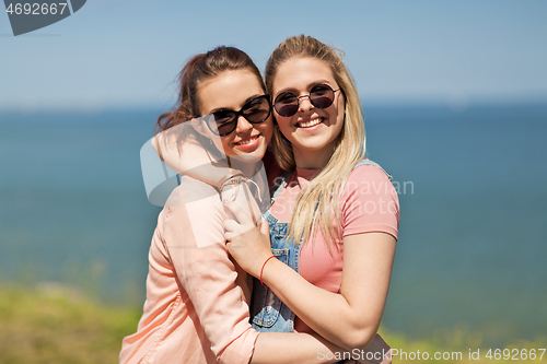 Image of teenage girls or best friends at seaside in summer