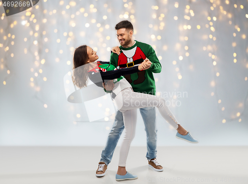 Image of couple dancing at christmas ugly sweater party