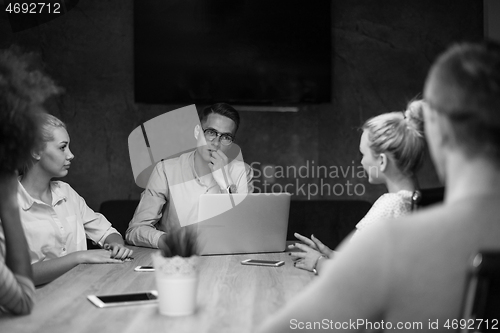 Image of Multiethnic startup business team in night office