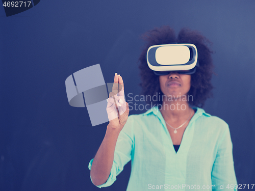 Image of black girl using VR headset isolated on gray background