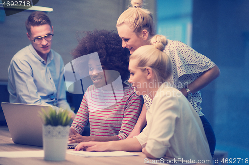 Image of Multiethnic startup business team in night office