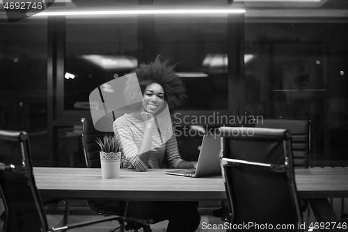 Image of black businesswoman using a laptop in startup office