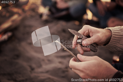 Image of Friends having fun at beach on autumn day