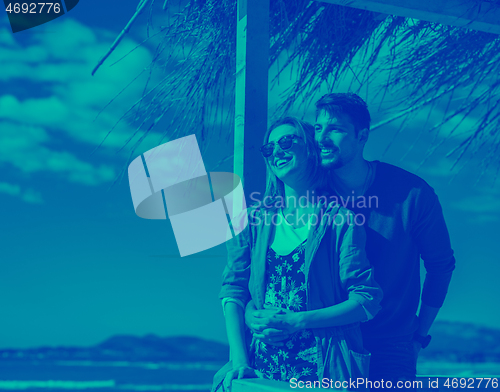 Image of Couple chating and having fun at beach bar