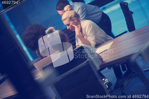 Image of Multiethnic startup business team in night office