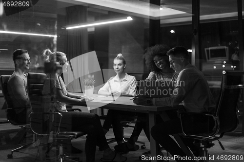 Image of Multiethnic startup business team in night office