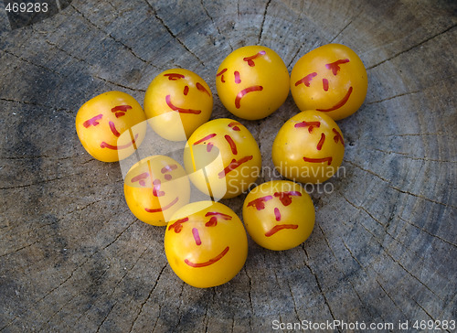 Image of yellow plums like emoticons