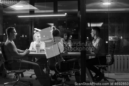 Image of Multiethnic startup business team in night office