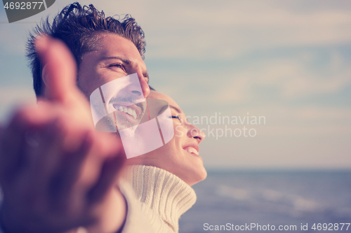 Image of Loving young couple on a beach at autumn sunny day