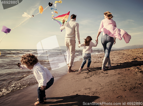 Image of happy family enjoying vecation during autumn day