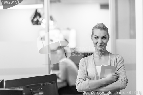 Image of Business Woman Using Digital Tablet in front of startup Office