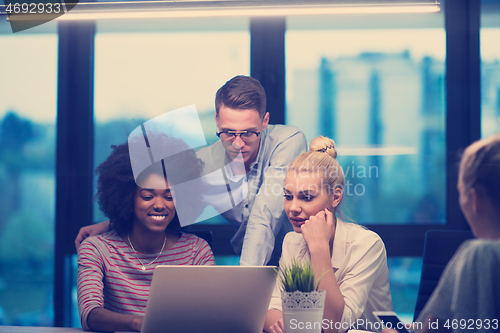 Image of Multiethnic startup business team in night office