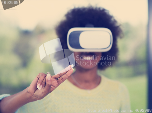 Image of black woman using VR headset glasses of virtual reality