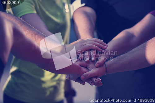 Image of runners giving high five to each other