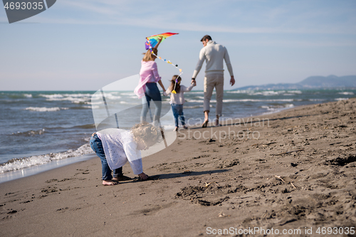 Image of happy family enjoying vecation during autumn day