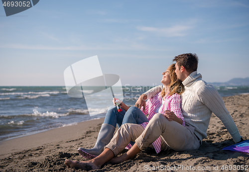 Image of young couple enjoying time together at beach