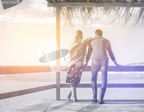 Image of Couple chating and having fun at beach bar