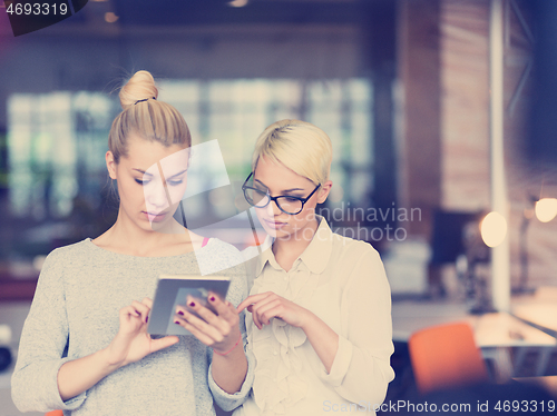 Image of Pretty Businesswomen Using Tablet In Office Building during conf