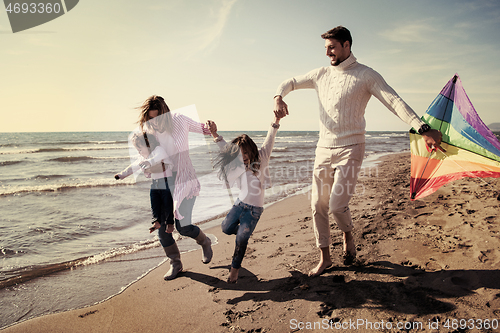 Image of happy family enjoying vecation during autumn day